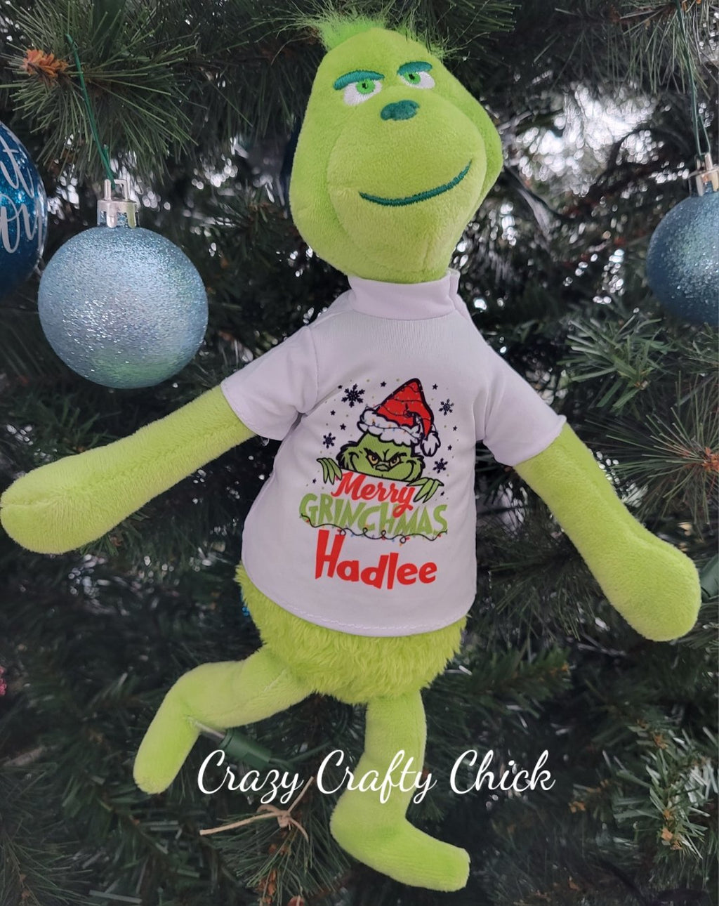 Personalized Grinch plush by the Christmas tree